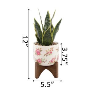 Flora Bunda 12 in. Faux Snake Plant in Flower Print White Ceramic Pot on Wood Stand